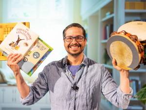 Man holding books and instruments